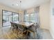 Charming dining area with stylish chandelier, gray woven chairs, and view of outdoor space at 18203 Pine Hammock Blvd, Lutz, FL 33548