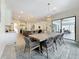Open dining area with view into kitchen and living room and outdoor area with furniture at 18203 Pine Hammock Blvd, Lutz, FL 33548