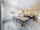 Dining area flows into open kitchen; features statement chandelier and view of cooktop at 18203 Pine Hammock Blvd, Lutz, FL 33548