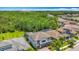 Two story home with a manicured lawn, with view of backyard landscaping and surrounding area at 18203 Pine Hammock Blvd, Lutz, FL 33548