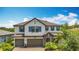 Gorgeous two-story home showcases a manicured lawn, stone accents, and a spacious two-car garage at 18203 Pine Hammock Blvd, Lutz, FL 33548