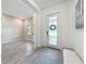 Bright foyer features a frosted front door, art, and stylish rug at 18203 Pine Hammock Blvd, Lutz, FL 33548