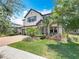 Inviting two-story home featuring lush landscaping, a brick driveway, and a well-maintained lawn at 18203 Pine Hammock Blvd, Lutz, FL 33548