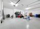 Bright, clean two-car garage with epoxy flooring offers plenty of room for parking and storage at 18203 Pine Hammock Blvd, Lutz, FL 33548