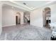 Hallway features arches and access to other rooms with neutral walls and tile floors at 18203 Pine Hammock Blvd, Lutz, FL 33548