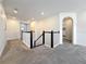 Upstairs hallway with carpet, black and white balusters, and archway into bedroom at 18203 Pine Hammock Blvd, Lutz, FL 33548
