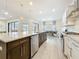 Spacious kitchen with a large island, granite countertops, stainless steel appliances, and an open-concept design at 18203 Pine Hammock Blvd, Lutz, FL 33548
