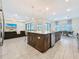 Open kitchen concept featuring an island with pendant lighting, granite countertops, and seamless flow into the living room at 18203 Pine Hammock Blvd, Lutz, FL 33548