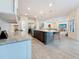 Kitchen island with breakfast bar, stone countertops, and stainless steel appliances at 18203 Pine Hammock Blvd, Lutz, FL 33548
