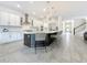 Well-lit kitchen featuring a large island, modern appliances, and stylish pendant lights at 18203 Pine Hammock Blvd, Lutz, FL 33548