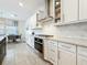 Beautiful kitchen featuring white cabinets, granite countertops, stainless steel appliances, and an adjacent dining area at 18203 Pine Hammock Blvd, Lutz, FL 33548