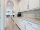 Bright kitchen space features white cabinets, granite countertops, and stainless steel appliances at 18203 Pine Hammock Blvd, Lutz, FL 33548