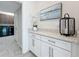 Laundry room featuring white cabinets and granite countertops at 18203 Pine Hammock Blvd, Lutz, FL 33548