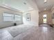 Bright living room features an arched ceiling, recessed lights, and stylish flooring at 18203 Pine Hammock Blvd, Lutz, FL 33548