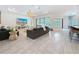 Spacious living room features a tv, access to the lanai, and an open-concept layout at 18203 Pine Hammock Blvd, Lutz, FL 33548