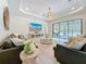 Spacious living room features two sofas, a tv, and access to the lanai at 18203 Pine Hammock Blvd, Lutz, FL 33548