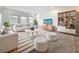 Bright living room featuring neutral decor, comfortable seating, and stylish built-in shelving at 18203 Pine Hammock Blvd, Lutz, FL 33548