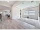 Bright living room features an arched ceiling, recessed lights, and modern flooring at 18203 Pine Hammock Blvd, Lutz, FL 33548
