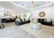 Spacious living room with two sofas and an open view of the modern kitchen at 18203 Pine Hammock Blvd, Lutz, FL 33548