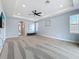 Expansive main bedroom with large windows, and neutral walls at 18203 Pine Hammock Blvd, Lutz, FL 33548
