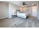 Nicely appointed main bedroom with large bed and bedside tables at 18203 Pine Hammock Blvd, Lutz, FL 33548