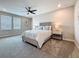 Nicely appointed main bedroom with large bed and bedside tables at 18203 Pine Hammock Blvd, Lutz, FL 33548