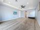 Spacious main bedroom with carpet and a lighted tray ceiling with ceiling fan at 18203 Pine Hammock Blvd, Lutz, FL 33548