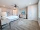 Nicely appointed main bedroom with large bed, TV and beside tables at 18203 Pine Hammock Blvd, Lutz, FL 33548