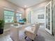 Bright office features a modern desk, white french doors, and light tile floors at 18203 Pine Hammock Blvd, Lutz, FL 33548