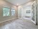 Bright office features a white french doors, neutral walls, and light tile floors at 18203 Pine Hammock Blvd, Lutz, FL 33548