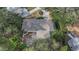 Overhead shot of a house among mature trees and lush surroundings, creating a private oasis at 1905 Pine Tree Ln, Belleair Bluffs, FL 33770
