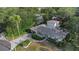 Stunning aerial view of a well-maintained home nestled among lush trees and showcasing a circular driveway at 1905 Pine Tree Ln, Belleair Bluffs, FL 33770