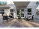 This relaxing back patio offers seamless indoor-outdoor living through its adjacent glass sliding door at 1905 Pine Tree Ln, Belleair Bluffs, FL 33770