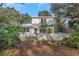 This home includes a fenced backyard, a second-story balcony, and a rear patio at 1905 Pine Tree Ln, Belleair Bluffs, FL 33770