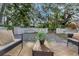 The backyard includes lush landscaping, stone ground cover, and inviting outdoor seating at 1905 Pine Tree Ln, Belleair Bluffs, FL 33770
