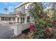 The backyard features a second-story balcony, comfortable seating, and beautiful flowers at 1905 Pine Tree Ln, Belleair Bluffs, FL 33770