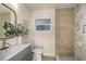 Beautiful bathroom with modern vanity and decorative shower tile at 1905 Pine Tree Ln, Belleair Bluffs, FL 33770