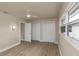 Cozy bedroom with light wood floors, ceiling fan, and access to the closet and doorway at 1905 Pine Tree Ln, Belleair Bluffs, FL 33770