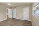 Bedroom with hardwood floors, white trim and doors, a ceiling fan, and natural light from a side window at 1905 Pine Tree Ln, Belleair Bluffs, FL 33770