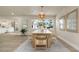 Dining room featuring modern light fixtures, wood table set, and view to the stairway at 1905 Pine Tree Ln, Belleair Bluffs, FL 33770