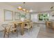 Dining room with a wooden table set, contemporary lighting, and an entrance to the front door at 1905 Pine Tree Ln, Belleair Bluffs, FL 33770