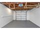 Spacious two car garage with a white door and grey flooring, offering secure parking and extra storage at 1905 Pine Tree Ln, Belleair Bluffs, FL 33770