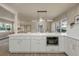 Spacious kitchen features a large island with modern countertops, white cabinets, and fixtures at 1905 Pine Tree Ln, Belleair Bluffs, FL 33770
