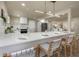 Modern kitchen with white countertops, cabinets and island with seating and stainless steel appliances at 1905 Pine Tree Ln, Belleair Bluffs, FL 33770