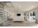 Open living room area with spiral staircase, neutral decor, recessed lighting, and vinyl flooring at 1905 Pine Tree Ln, Belleair Bluffs, FL 33770