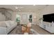 Bright living room features lots of natural light, recessed lighting, and a decorative spiral staircase at 1905 Pine Tree Ln, Belleair Bluffs, FL 33770