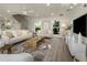 Bright living room features lots of natural light, recessed lighting, and a decorative spiral staircase at 1905 Pine Tree Ln, Belleair Bluffs, FL 33770