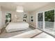 Bright main bedroom boasts lots of natural light and a private balcony at 1905 Pine Tree Ln, Belleair Bluffs, FL 33770