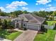 Beautiful home with a well-kept lawn, brick driveway, and a spacious backyard at 21028 Ski Way, Land O Lakes, FL 34638