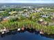 Expansive aerial view of homes nestled among trees with lake access and private docks at 21028 Ski Way, Land O Lakes, FL 34638